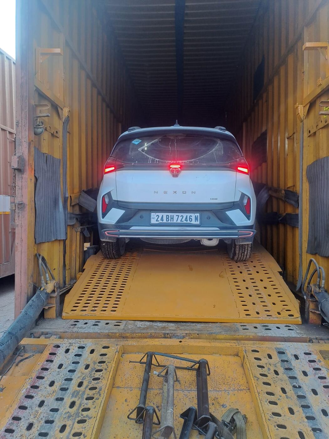 Tata Nexon being driven up the ramp into an Agrasen Trans Logistics car carrier