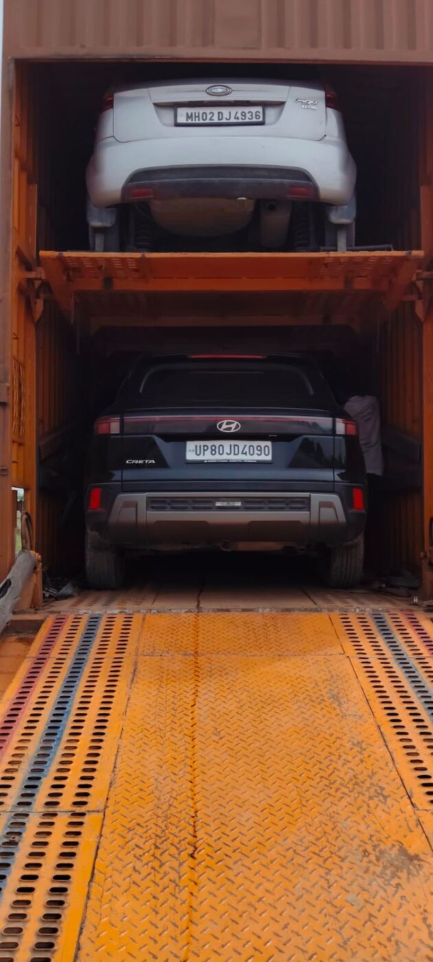 Two cars loaded on separate levels of a car carrier